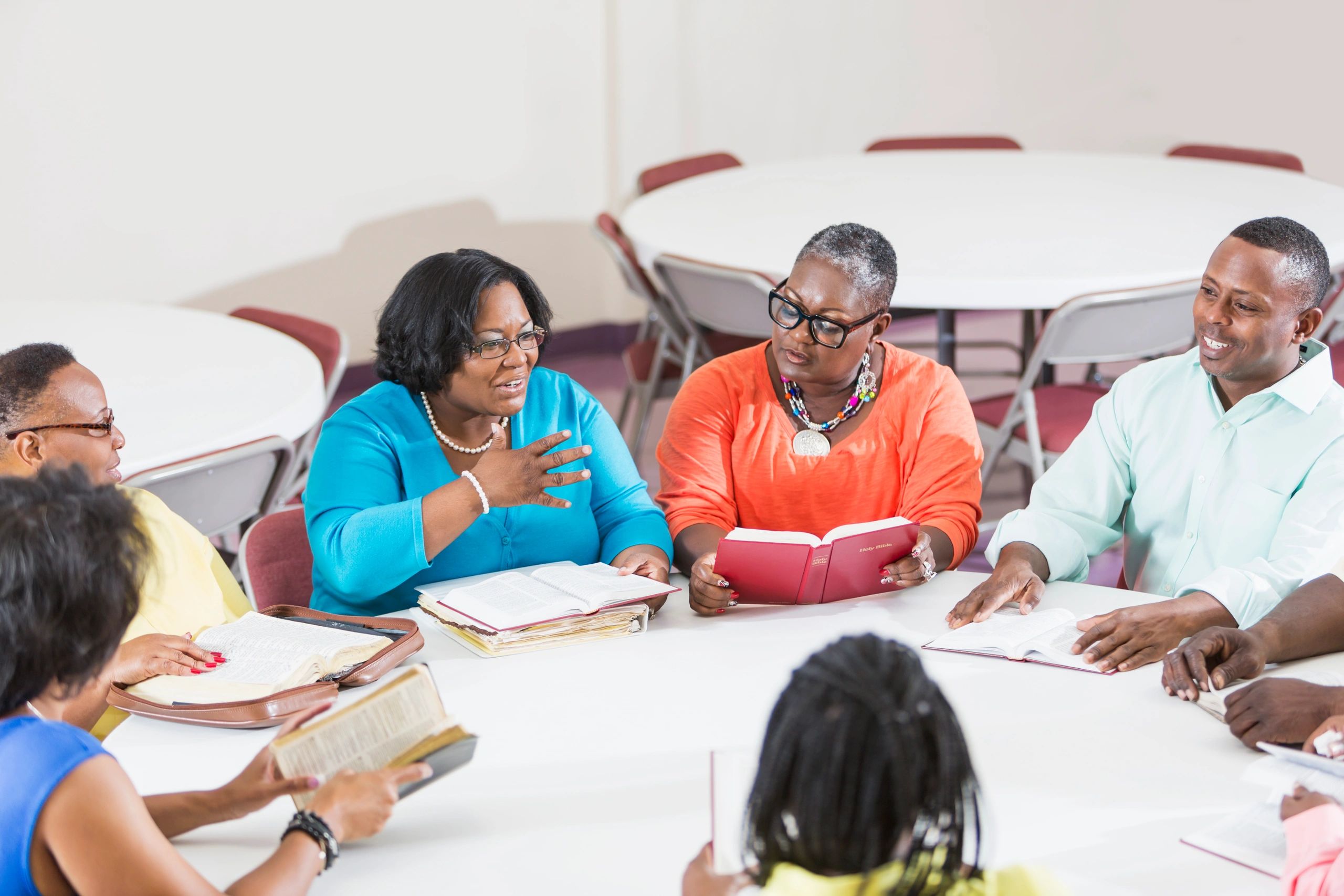 Bible study group seated with open Bibles